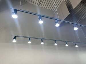 Illuminated track lights and a ceiling fan in a commercial space