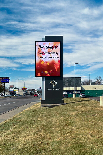 Tall roadside digital display beside a parking area