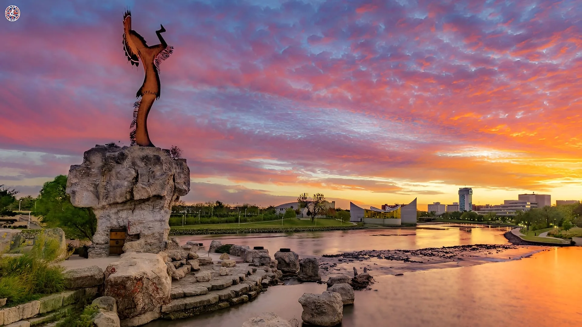 The Keeper of the Plains and Wichita skyline beside the Arkansas River at sunset